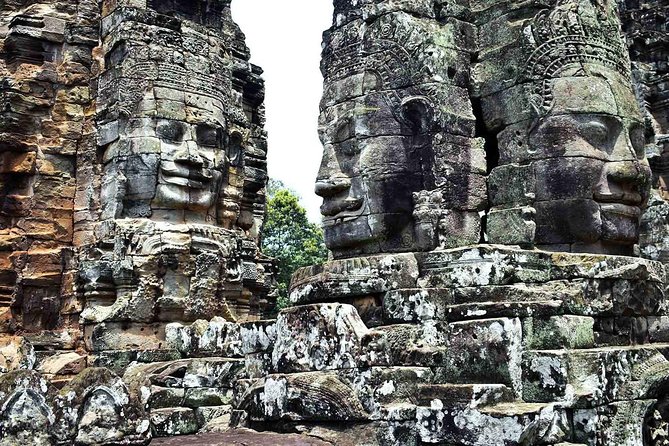 Four-day tour Angkor Wat, Banteay Srey, Beng Melea and Siem Reap discovery - Day 1 Through Angkor Thom: Bayon Faces, Ta Prohm Roots, Banteay Kdei, and Angkor Wat